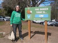 Mercedes Bermejo standing by "Fire Danger Today is Low" sign