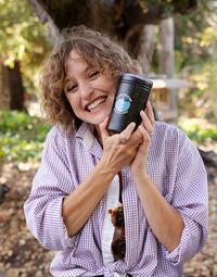 Raffle prize winner holds up coffee tumbler