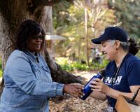 Raffle prize winner presented water bottle from Marci Burke