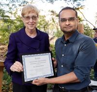 Vice Chancellor for Research Dr. Katherine Yelick presents the postdoc award to Sunkalp Shukla