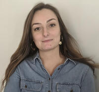 Headshot of Julie Pachurka wearing a denim shirt in front of white background