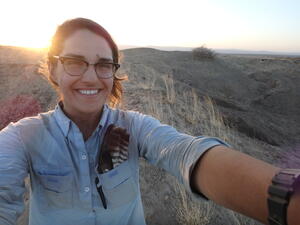 Marianne Brasil outdoors in a nature setting with sunset in background