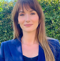 Gabriella Di Pascale headshot wearing blue jacket