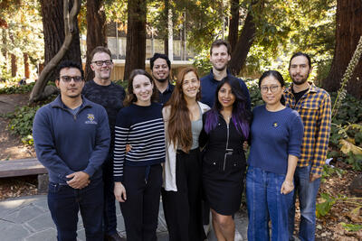 Berkeley Postdoc Association 2023-2024 Board Members posing in two rows with trees in background.