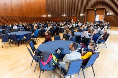 Career Fair event with multiple tables and attendees sitting around tables.