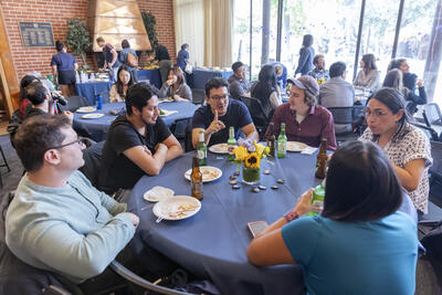 Postdocs sitting around table and chatting at PostdocFest event.